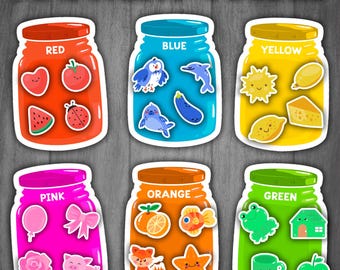 May include: Six colorful jars with lids, each labeled with a color: red, blue, yellow, pink, orange, and green. Each jar contains various images of objects in the corresponding color.