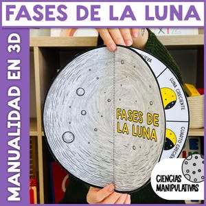 Pode incluir: Um artesanato educativo 3D sobre as fases da lua. O artesanato apresenta uma grande lua circular cinzenta com crateras e o texto "FASES DE LA LUNA" em amarelo. As fases da lua estão rotuladas em espanhol.