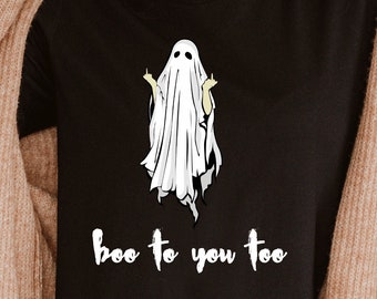 May include: Black t-shirt with a white ghost graphic and the phrase "boo to you too". The ghost illustration has yellow accents. The shirt is part of a Halloween-themed collection.