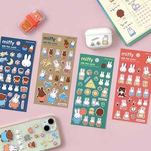 May include: Four sheets of colorful stickers featuring a cartoon bunny rabbit named Miffy. The stickers are in blue, green, red, and brown. Each sheet has a different design and includes various images of Miffy in different poses and activities. The text on the stickers reads "miffy" and "우선 스티커".