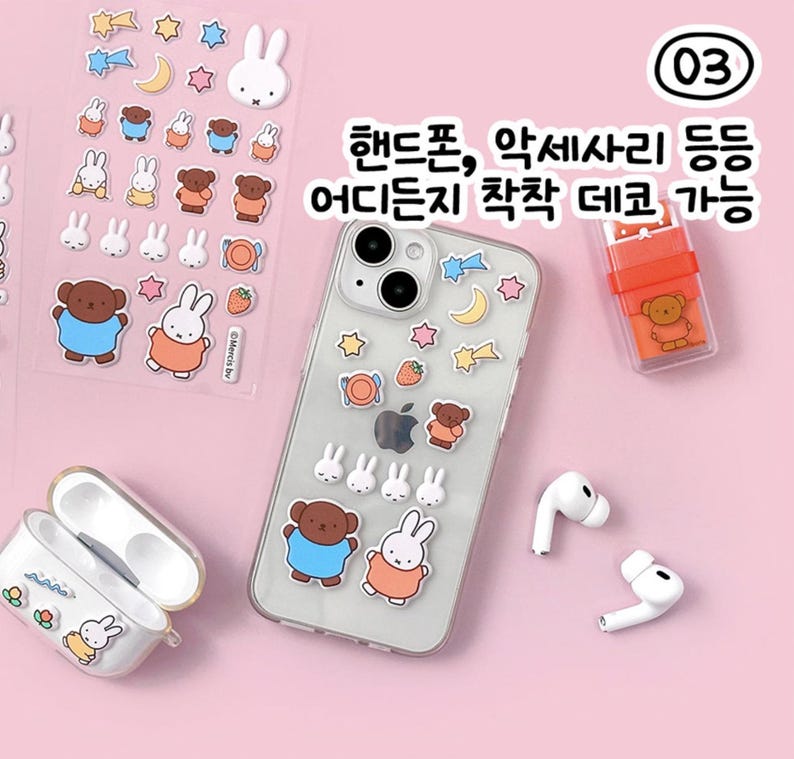 May include: A set of colorful stickers featuring cartoon bears and bunnies. The stickers are designed to be applied to a phone case, AirPods case, or other smooth surfaces. The stickers are available in a variety of colors and designs, including stars, moons, and strawberries. The text on the image reads "핸드폰, 액세서리 등 어디든지 착착 떼고 가능", which translates to "Phone, accessories, etc. can be easily removed anywhere".