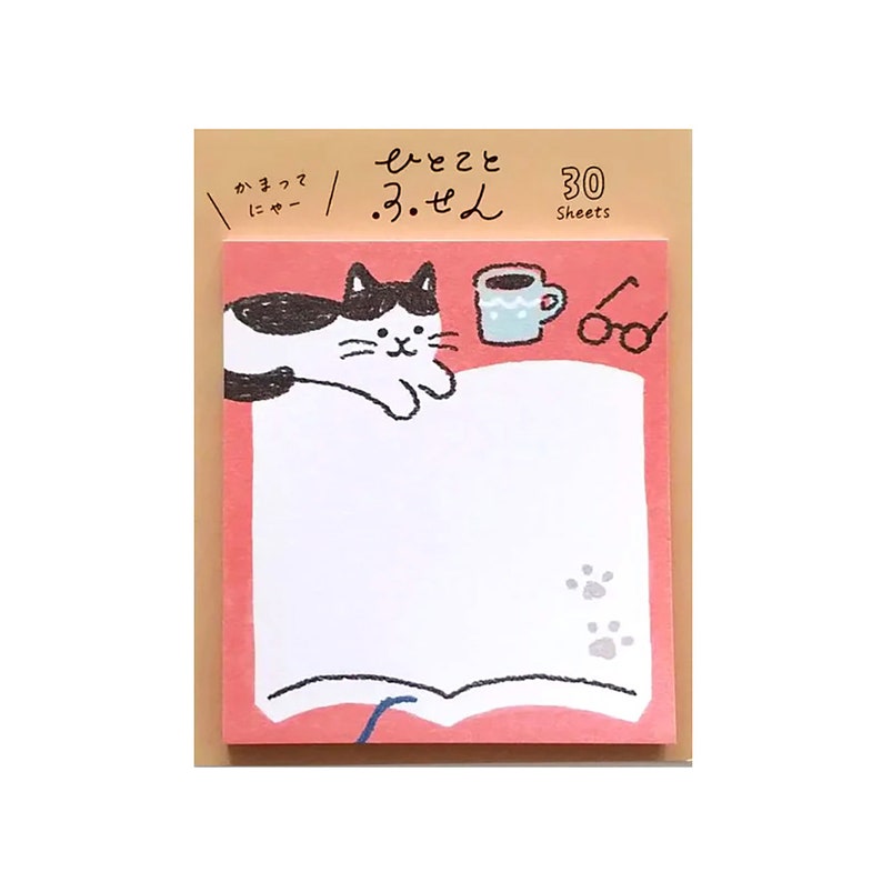 May include: A pink and white notepad with a cartoon cat, coffee cup, and glasses illustration. The notepad has a white writing area, paw prints, and the text "30 Sheets". The notepad is on a brown background.