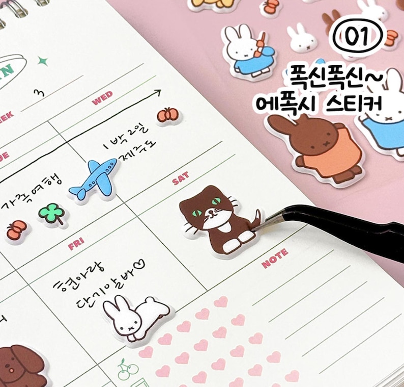 May include: A weekly planner with stickers featuring a variety of cute animals, including a cat, rabbit, and a brown bear. The stickers are labeled "폭신폭신~ 에폭시 스티커" which translates to "Soft and fluffy epoxy stickers".