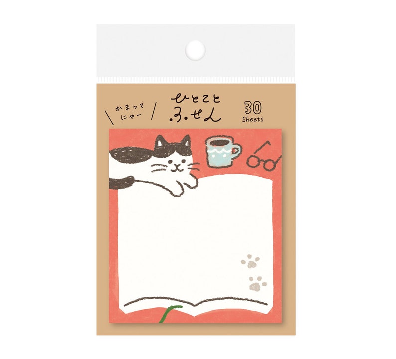 May include: A notepad with a cat illustration, a coffee cup, and glasses. The notepad has a red border and a white writing area. The text on the notepad is in Japanese. The notepad has 30 sheets.