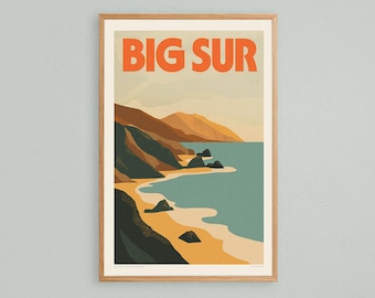 May include: Framed art print featuring a coastal landscape with the text "BIG SUR" in orange. The artwork depicts a beach, ocean, and mountains in shades of blue, green, brown, and tan. The print is in a wooden frame.