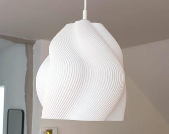 May include: A white pendant light fixture featuring a textured, spiraling, wave-like pattern across its exterior surface. The lamp shade has a rounded, organic shape and is suspended from a single white cord attached to the top center.
