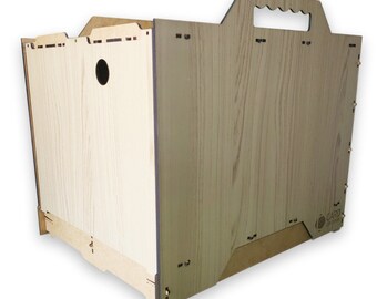 May include: A wooden crate with a handle on the top. The crate is made of light brown wood with a wood grain pattern. The crate has a small hole on the side. The crate is labeled "CARD BOARD"
