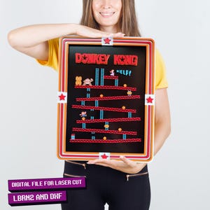 May include: A digital file for laser cutting a Donkey Kong arcade game design. The design features the iconic Donkey Kong game characters and the text "Donkey Kong" and "HELP!" in red. The file is available in LBRN2 and DXF formats.