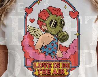 Love Is In The Air Graphic T-Shirt – Funny Anti Valentine Cupid Tee | Gas Mask Angel Shirt, Unisex Statement Tee