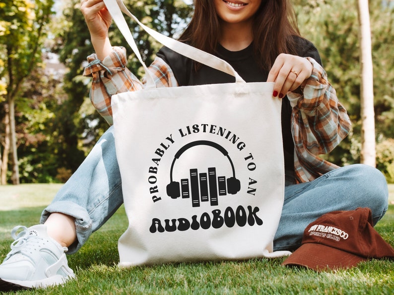 A cotton canvas tote bag that says probably listening to an audiobook.