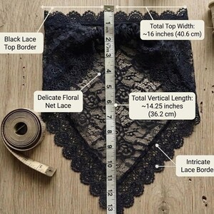 May include: A black lace bandana featuring a delicate floral net pattern and an intricate scalloped lace border. A measuring tape shows a total top width of 16 inches and a total vertical length of 14.25 inches, with a black lace top border.