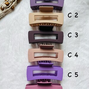 May include: Six plastic hair clips in various colors, including purple, pink, and beige. The clips are arranged vertically, with the top clip labeled "C1" and the bottom clip labeled "C6".