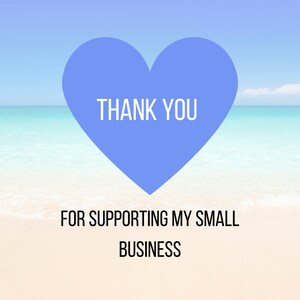 May include: A blue heart with the text "THANK YOU" on a white sandy beach with blue ocean water in the background. The text "FOR SUPPORTING MY SMALL BUSINESS" is below the heart.
