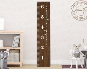 May include: A brown wooden ruler with white numbers and the text "watch me grow" written vertically on the right side. The ruler is against a white wall with a shelf unit and a toy on the floor.