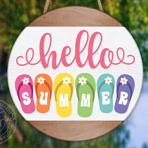 May include: A round wooden sign with the text "hello summer" in pink script.  The word "summer" is spelled out with colourful flip-flops.