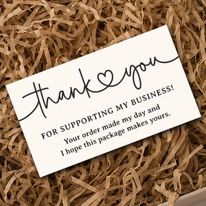 May include: A rectangular white thank you card with black text that reads: thank you FOR SUPPORTING MY BUSINESS! Your order made my day and I hope this package makes yours. The card is placed inside a square cardboard box filled with brown paper filler.