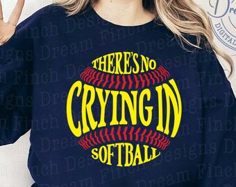 May include: A navy blue sweatshirt with the text "There's no crying in softball" printed on it in yellow and red. The text is inside a red and white softball graphic.
