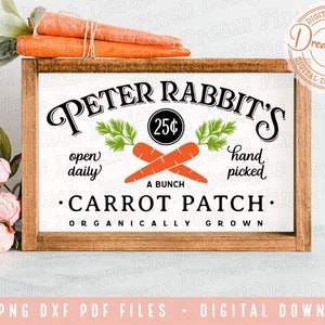 May include: A wooden sign with the text "Peter Rabbit's Carrot Patch. Organically Grown" and a drawing of carrots and greenery. The sign also says "Open Daily" and "Hand Picked" with a price of 25 cents for a bunch of carrots.