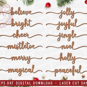 May include: A collection of wooden laser-cut Christmas words in a cursive font, such as "believe," "bright," "cheer," and "mistletoe." Each word has a decorative line beneath it. The image also features festive decorations like baubles and sprigs of greenery, creating a seasonal theme.