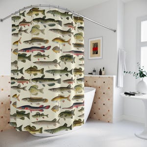 May include: A shower curtain featuring a repeating pattern of various fish illustrations in shades of green, yellow, and red on a cream background. The curtain is hanging in front of a white bathtub.