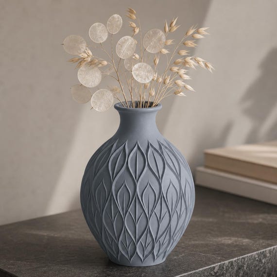 Close-up of the Blue Grey CanopyMuse leaf relief vase with pale lunaria and oat stems