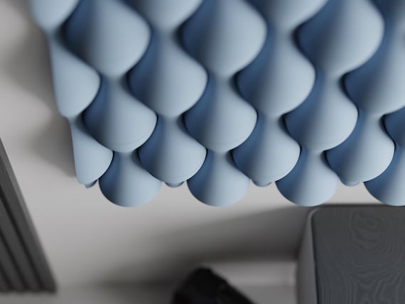 Angled close-up of blue HaloWeave wall tiles showing their deep convex relief