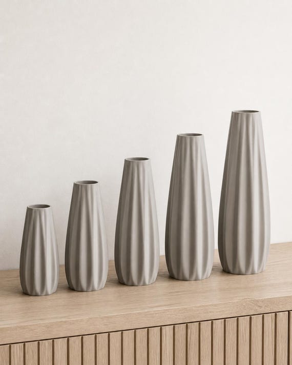 Close-up comparison of the five proportional Loomrise vase heights in Ash Gray