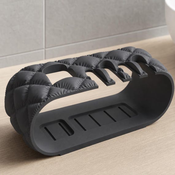 Close-up Charcoal CloudRidge organizer showing its quilted end and slotted platform