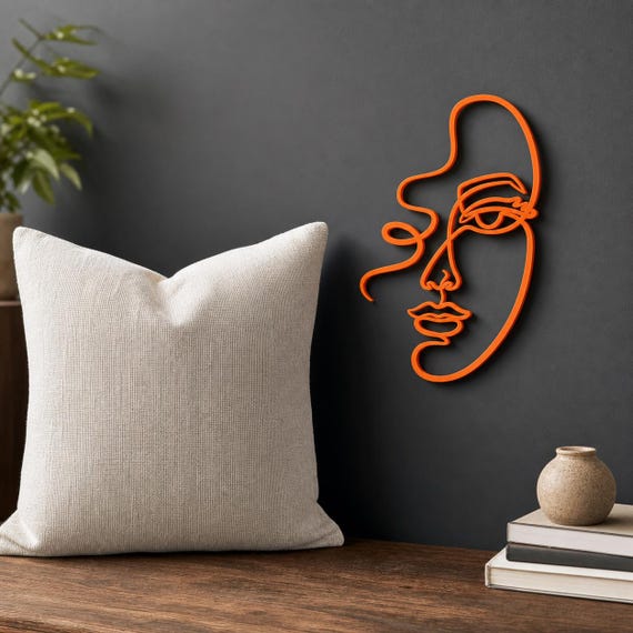 Abstract Woman Face wall art in Orange in a contrasting showcase room