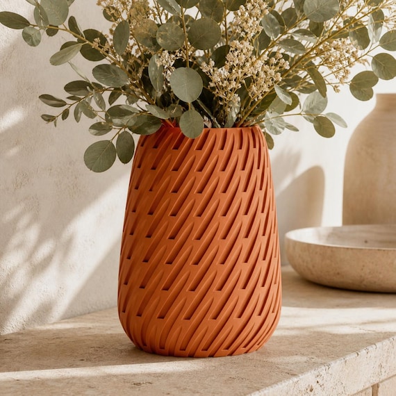 Close-up of the Terracotta Leafstream lattice vase with a muted eucalyptus arrangement