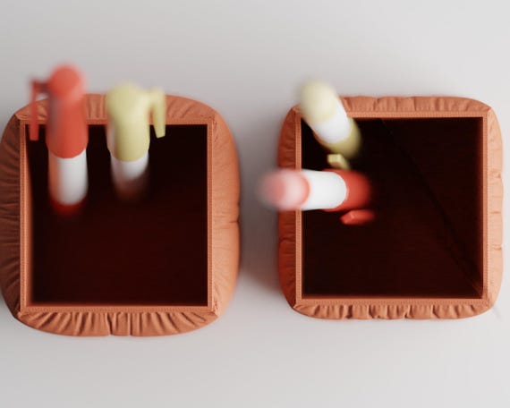 Top close-up of the open square interiors of the CushionCove pen holder options