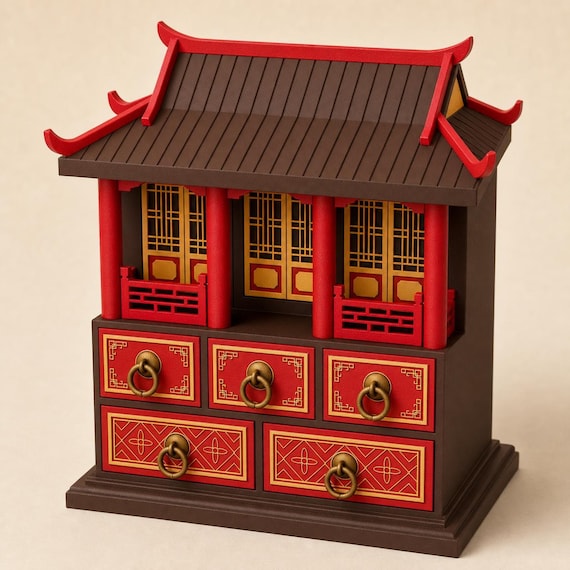 Heritage Brown pavilion keepsake chest with scarlet pillars and drawer fronts, antique-gold lattice panels and ring pulls, front three-quarter view