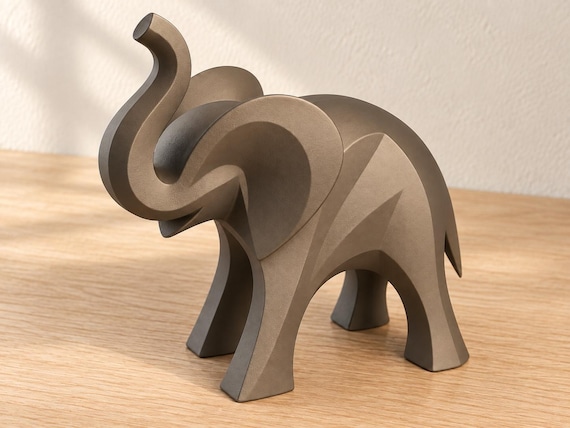 Warm taupe elephant sculpture, close-up alternate camera angle on pale oak against an ivory wall.