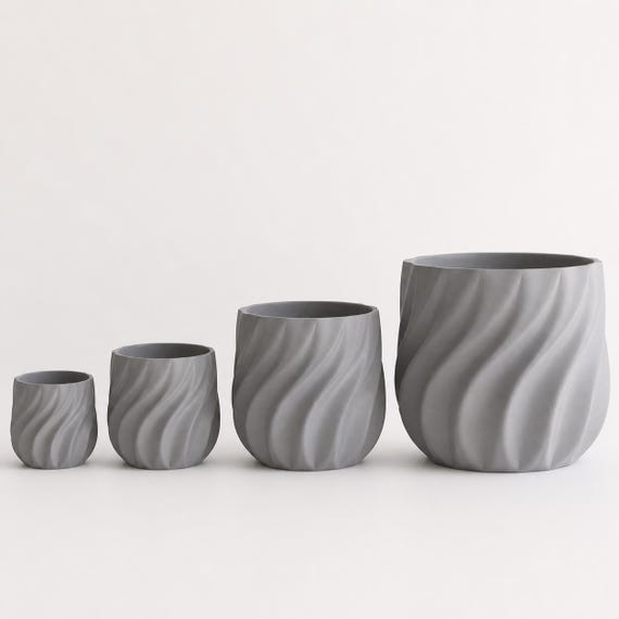 Four Grey CurrentFold planters arranged from the smallest size to the largest size