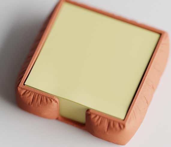 High-angle close-up of the GatherPad square sticky note holder in Terracotta