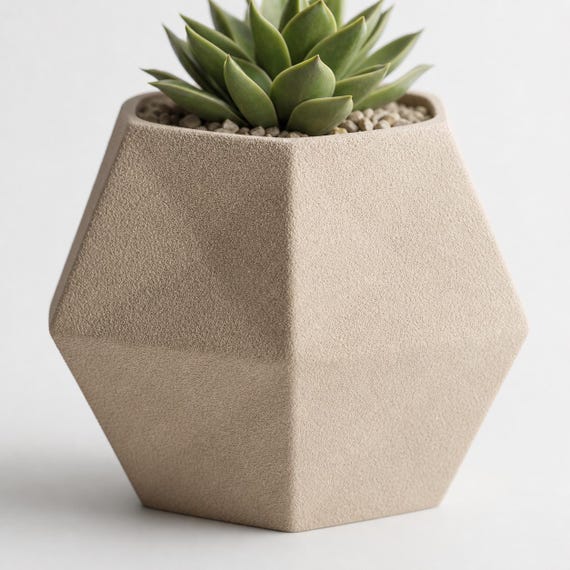 Macro close-up of the Beige Wide Crest planter showing its pebbled texture and crisp faceted ridge