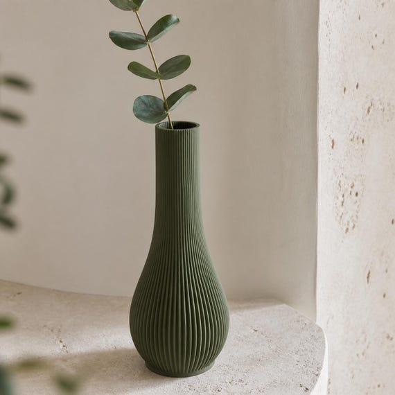Close-up of the Dark Green Serein single stem vase with a eucalyptus sprig