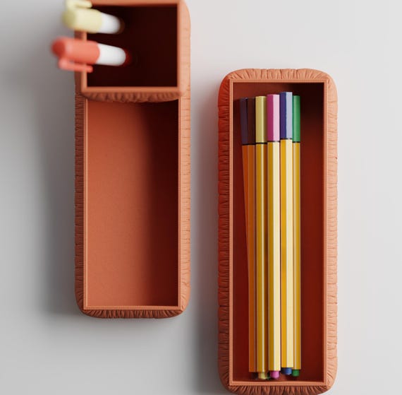 Top close-up of the GatherFold pen holder and long pencil tray in Terracotta