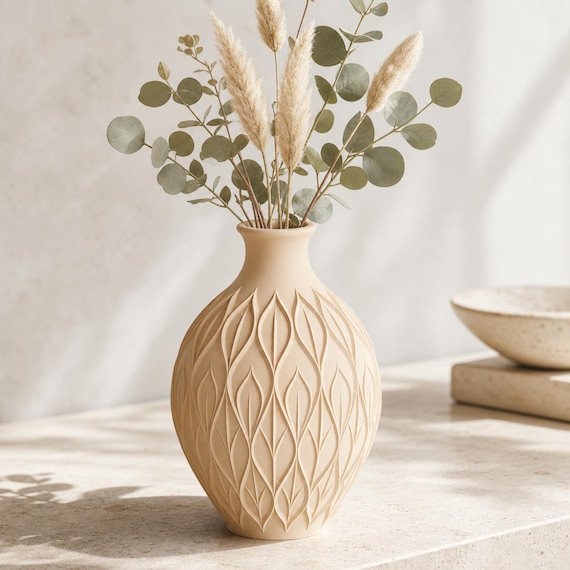 Close-up of the CanopyMuse leaf relief vase in Beige with dried eucalyptus and pampas stems
