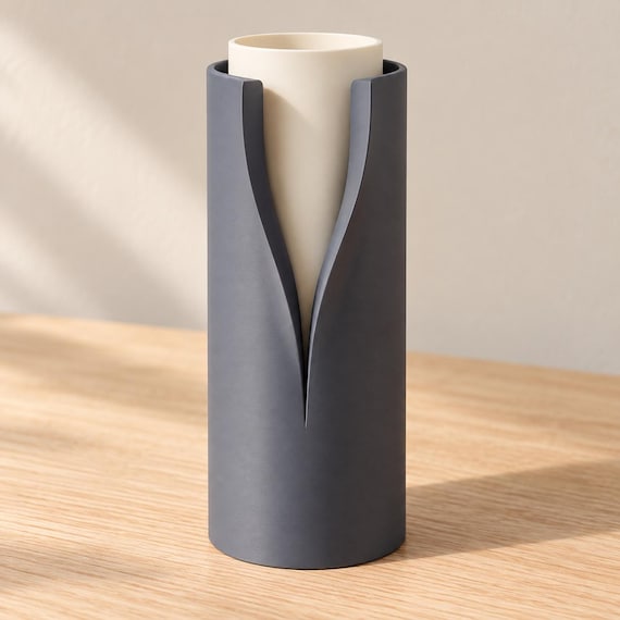 Chalk Ink Vellori vase with a Charcoal outer collar and Ivory White inner vessel, showing the deep curved opening on an oak tabletop.
