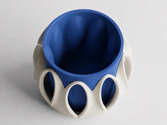 Elevated view into the Arcloom planter in Coastal, showing Ivory White arches and a Marine Blue inner pot on a pale gray background.