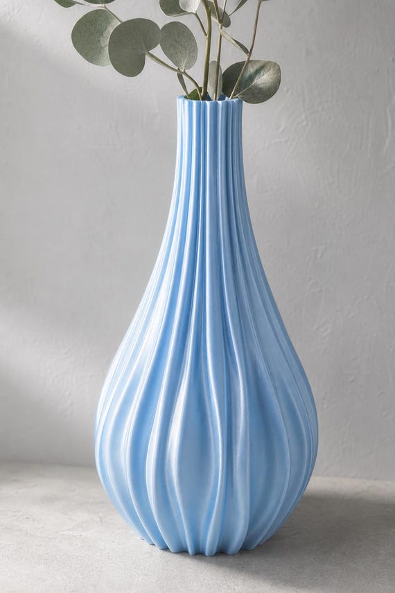 Close-up of the PulsePetal tall vase in Silk Baby Blue with eucalyptus stems