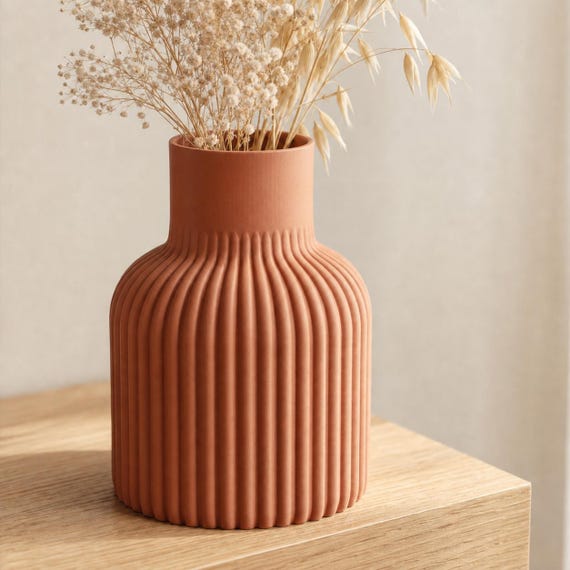 Close-up of the Solenne fluted vase in Terracotta with dried cream botanicals