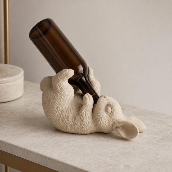Opposite-angle close-up of the Ivory White rabbit holder displaying a plain mini bottle neck-first