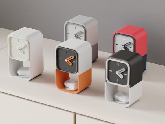 Pocketime Storage Desk Clock examples in contrasting colors on a pale cabinet, with white earbud cases shown in the lower spaces.
