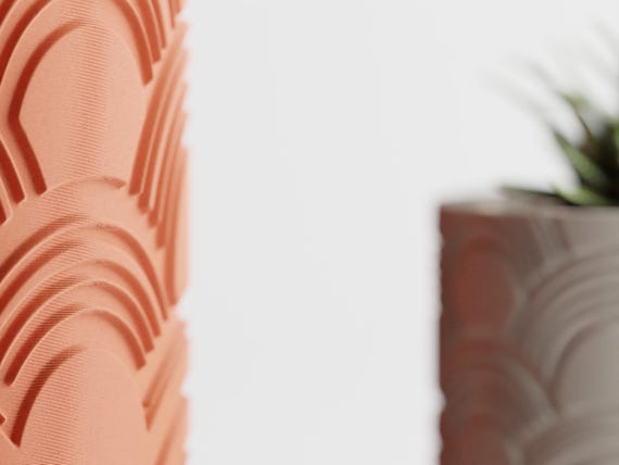 Close-up side view comparing raised ArcEcho planter textures from two angles