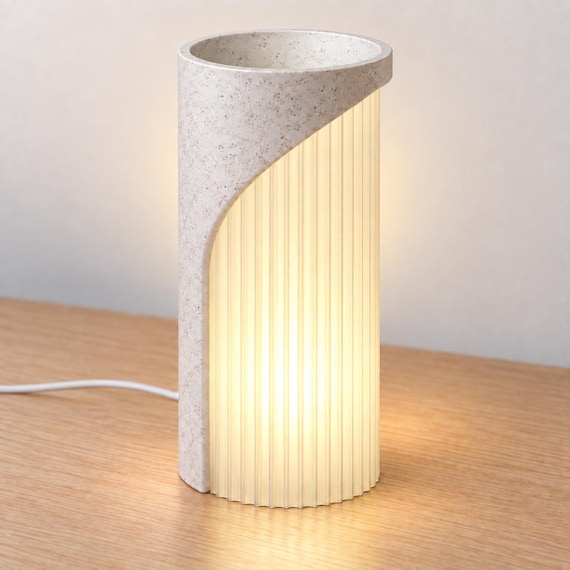 Elevated view of Marble Glow Caldora with a White Marble speckled back/top, open rim and warm Mellow Yellow ribbed diffuser.