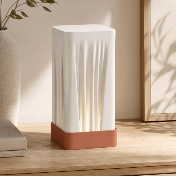 Terracotta Dawn Woven Glow table lamp on a light wood console