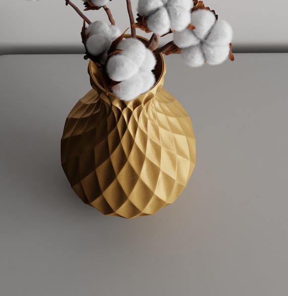High-angle close-up of the Gold LatticeGourd vase, narrow opening, and geometric relief