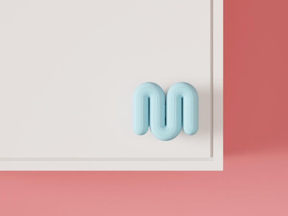 Light blue wavy cabinet knob on a white cabinet, angled close-up.